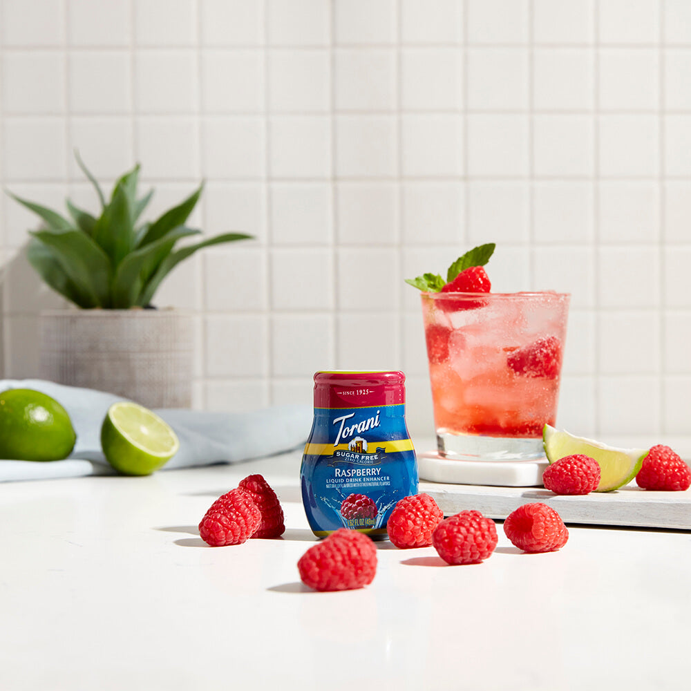 Sugar Free Raspberry Liquid Drink Enhancer with raspberry and lime in the kitchen